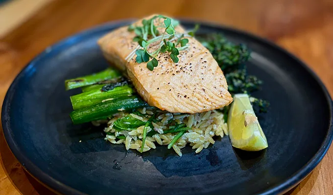 Oven-Baked-Salmon_Mobile Oven baked salmon on top of asparagus and rice with a lemon wedge